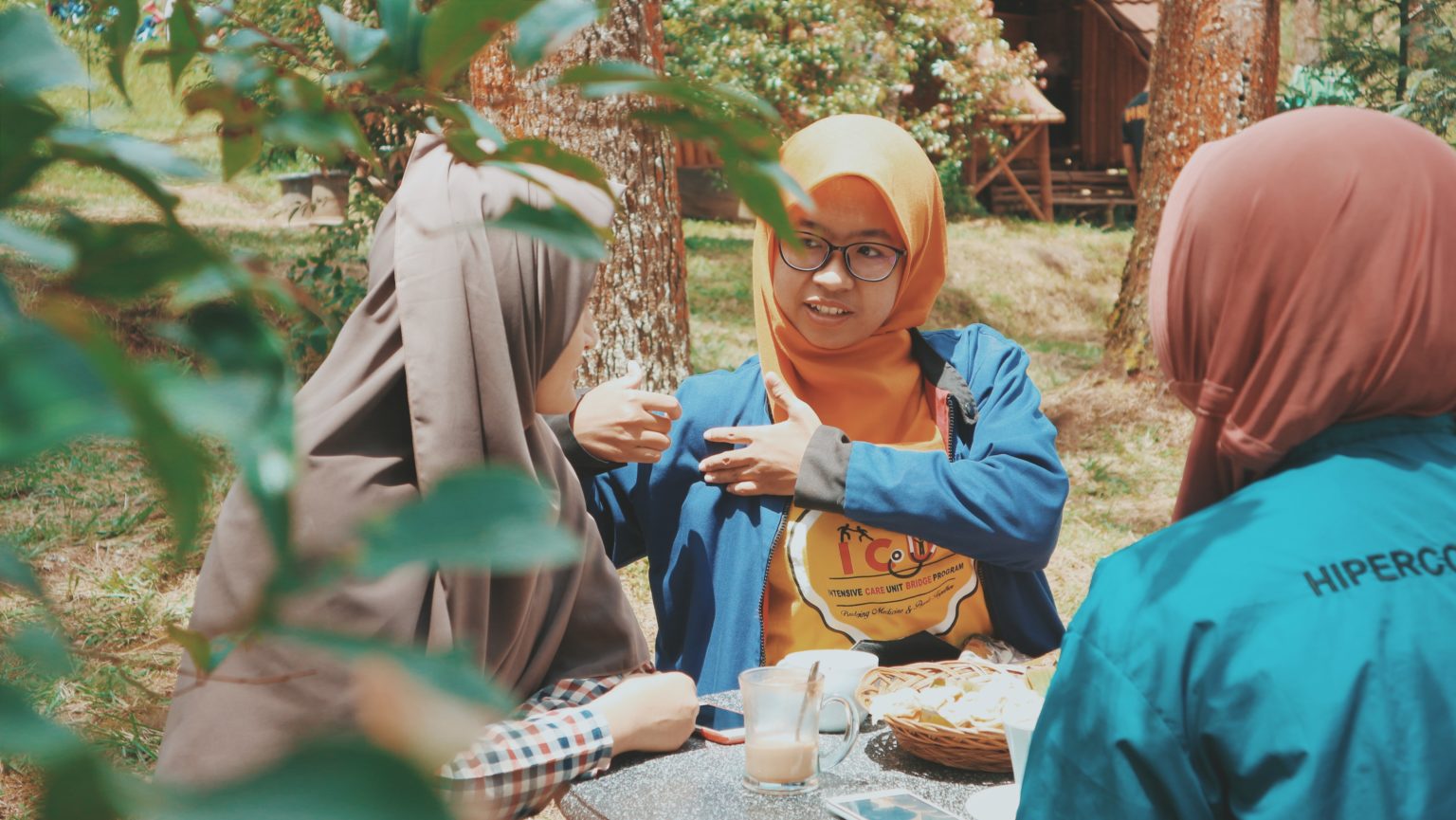 A group of people talking outside at a picnic