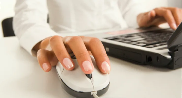 Close up photo of a computer user's hand clicking a mouse